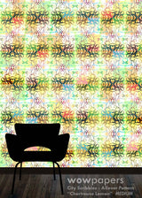 A repeating multicolor patterned wallpaper or wall covering shown in a room mockup, with a black chair silhouette at the bottom against a light cream background and dark floor. Text at the bottom reads 'wowpapers City Scribbles : Allover Pattern Chartreuse Lemon MEDIUM'.