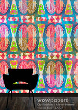 A colorful repeating allover pattern wallpaper design in fuchsia blue, featuring abstract geometric shapes and stylized bottle silhouettes, shown with a black chair silhouette on a dark floor. Text at the bottom reads 'wowpapers City Scribbles - Allover Pattern "Fuscia Blue" LARGE'.