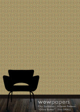 Olive Butter City Scribbles allover pattern wallpaper shown on a wall above a black chair silhouette and dark wood floor, with a Wowpapers watermark at the bottom.