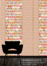 A wallpaper sample design labeled 'wowpapers City Scribbles Vertical Stripes Rose Gold SMALL' showing a repeating pattern of stylized figures in pink, gold, and white vertical stripes, with a black chair silhouette in front on a wood floor.
