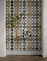 gold and beige wallpaper scaled to fit a niche with a table and decorative objects