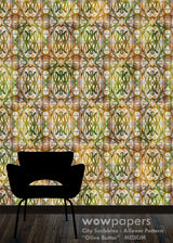 A repeating wallpaper pattern in olive green, yellow, beige, and brown tones, shown behind a black chair silhouette on a dark wood floor. Text at the bottom reads 'wowpapers City Scribbles : Allover Pattern "Olive Butter" MEDIUM'.