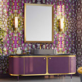 Purple and gold vanity with mirror against a large patterned pink and green wallpaper