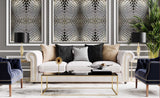 Modern living room with a white sofa, decorative pillows, and patterned wall art.